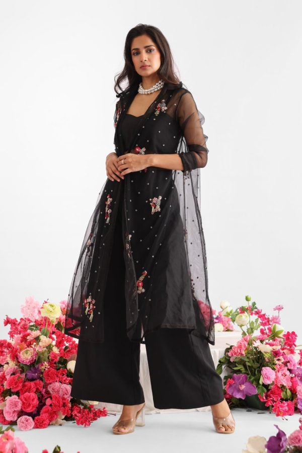 Black embroidered net and silk organza jacket with floral motifs, colorful tassels, lace detailing, paired with black bustier and flared pants – Golden Muslin