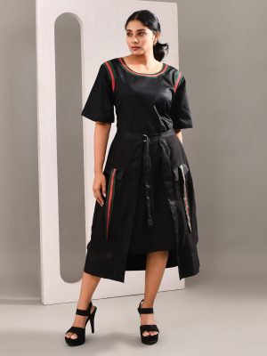 “Golden Muslin casual black blended cotton dress with sheer wrap-over skirt tied at the waist, creating a layered modern silhouette.”