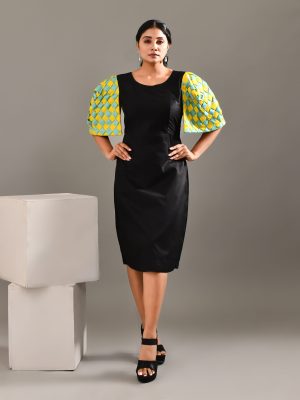 “Golden Muslin black cotton dress with bold exaggerated sculpted shoulders and intertwined vibrant sleeve detailing.”