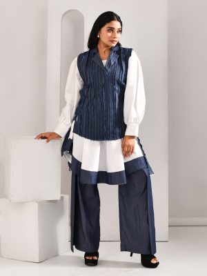 “Golden Muslin white and denim blue blended cotton and organza three-piece co-ord set with flat pants, high-low textured shirt, and tie-up jacket featuring denim-inspired detailing.”