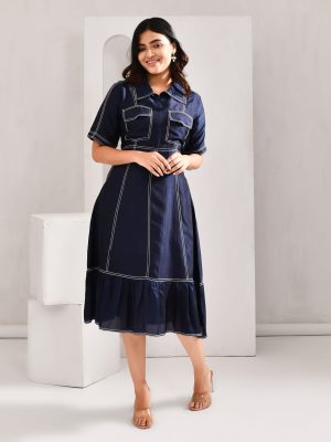 “Golden Muslin deep midnight blue blended cotton dress with silk-like sheen and anchoring threads highlighting a panelled structure.”