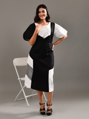 “Golden Muslin black blended cotton dress with chic puff sleeves and delicate white cord work embroidery.”