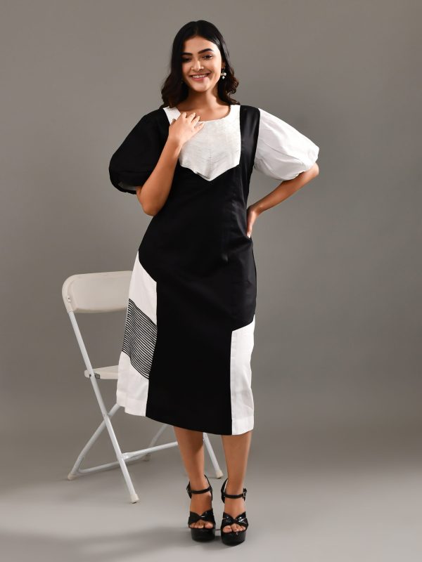 “Golden Muslin black blended cotton dress with chic puff sleeves and delicate white cord work embroidery.”