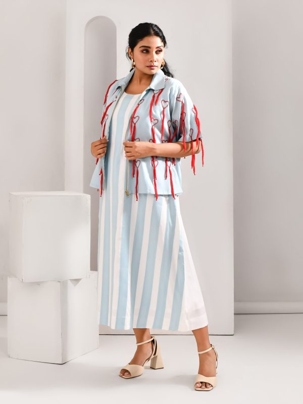 “Golden Muslin powder blue and white blended cotton dress with broad-stripe patchwork, paired with jacket featuring crimson quirky embroidery.”
