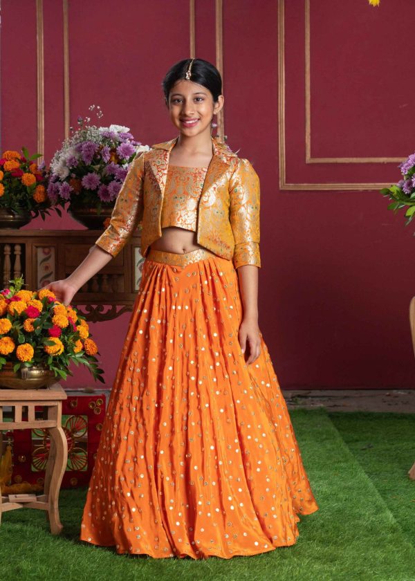 Orange brocade girls’ jacket top and lehenga set with floral motifs, golden gota work, and three-quarter sleeve jacket – Golden Muslin