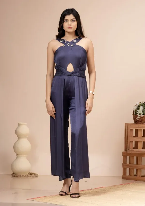 Navy blue satin halter jumpsuit with a keyhole cutout and twisted waist By Kumar Rahul from the house of Golden Muslin.