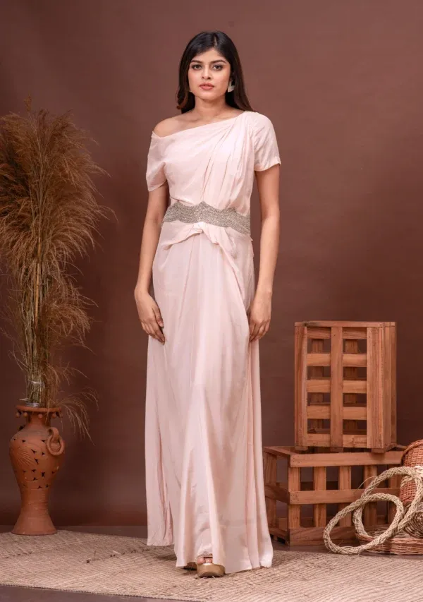 Champagne pink habutai silk drop shoulder gown with waist embroidery from the house of Golden Muslin by Kumar Rahul.