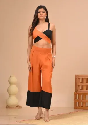Black and orange georgette crisscross strappy bustier and pleated culottes from the house of Golden Muslin by Kumar Rahul.