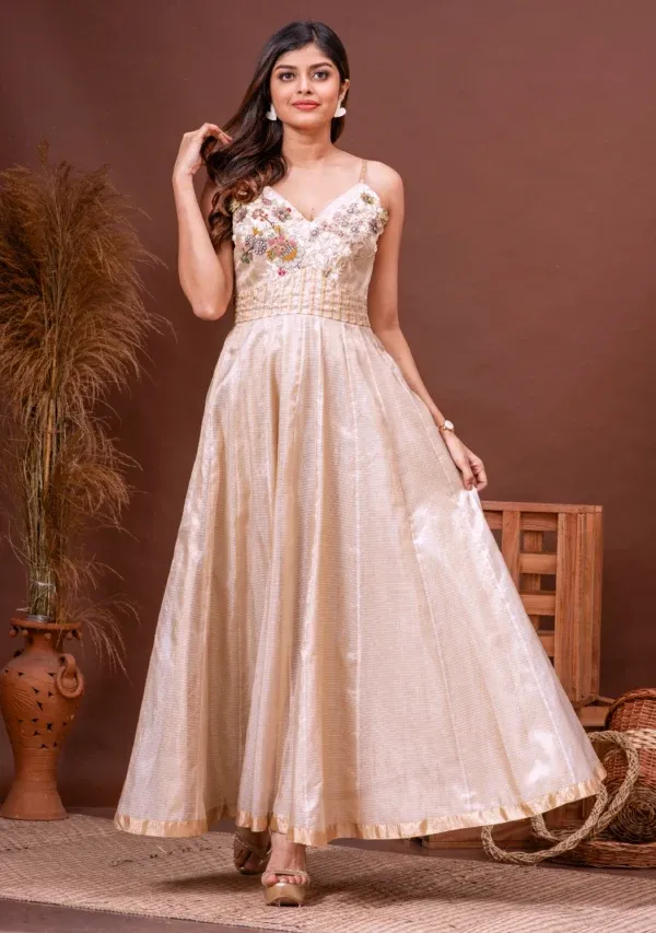 Beige zari kota doriya gown with floral zardosi embroidery from the house of Golden Muslin by Kumar Rahul.