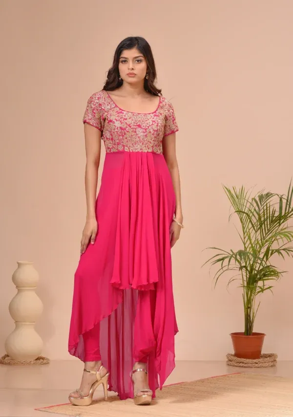 Coral georgette scoop neck tunic with an embroidered bodice and pleated hem from the house of Golden Muslin by Kumar Rahul.