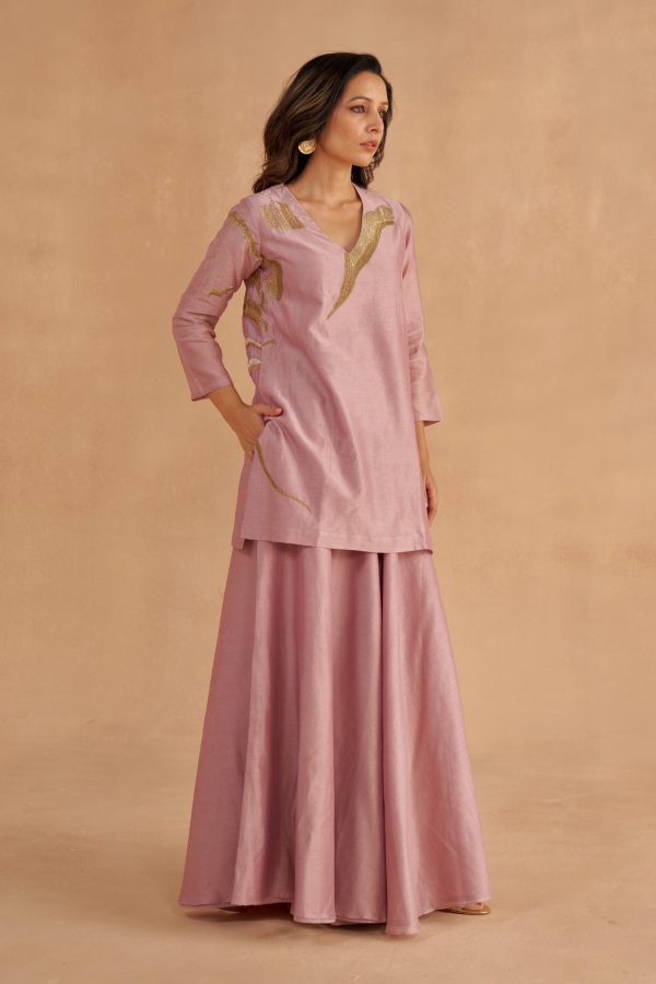 “Golden Muslin lilac Chanderi silk short kurta with Zardozi lotus motif and V-neckline, paired with lilac Chanderi Sharara pants with waist belt, pockets, and modern slit.”