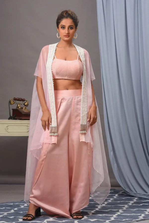 Baby pink organza cape, quilted bustier, and palazzo from the house of Golden Muslin by Satya JB with tassel details.