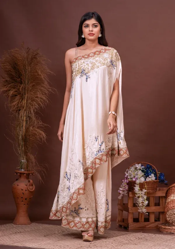 Beige Bamberg silk asymmetric cape and sharara from the house of Golden Muslin by Satya JB with floral sequins.