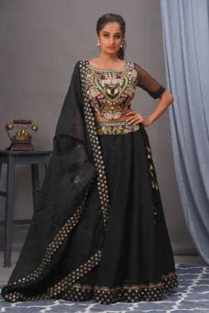 Black Bamberg silk lehenga with multicolored embroidery and organza dupatta by Satya JB from the house of Golden Muslin.
