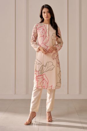 “Golden Muslin champagne pink lotus-print long straight kurta with pin tucks on body and sleeves, paired with champagne pink muslin silk tapered drawstring pants.”