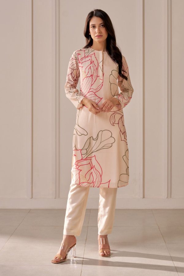 “Golden Muslin champagne pink lotus-print long straight kurta with pin tucks on body and sleeves, paired with champagne pink muslin silk tapered drawstring pants.”