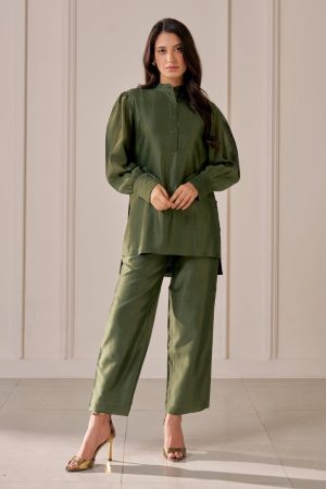 “Golden Muslin bottle green Chanderi shirt with zari Tuberose embroidery on sleeves, petal-shaped yoke, stand collar, concealed placket, uneven hem, paired with matching tailored straight-leg trousers.”