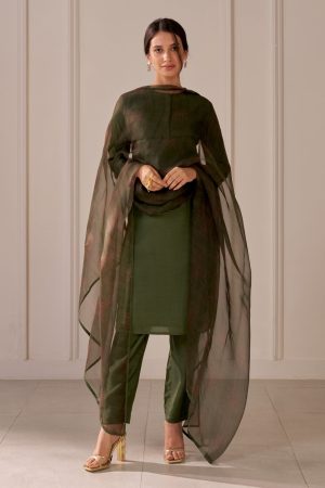 “Golden Muslin bottle green muslin silk kurta with floral zari embroidery on the back and pin tucks, paired with tapered muslin silk pants with drawstrings and a printed organza dupatta with beaded tassels and zari edges.”