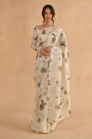 “Golden Muslin vintage ivory Paper Tussar saree with transitioning green-to-brown chintz print, paired with a black-and-white chintz printed bustier-style blouse with sweetheart neckline.”