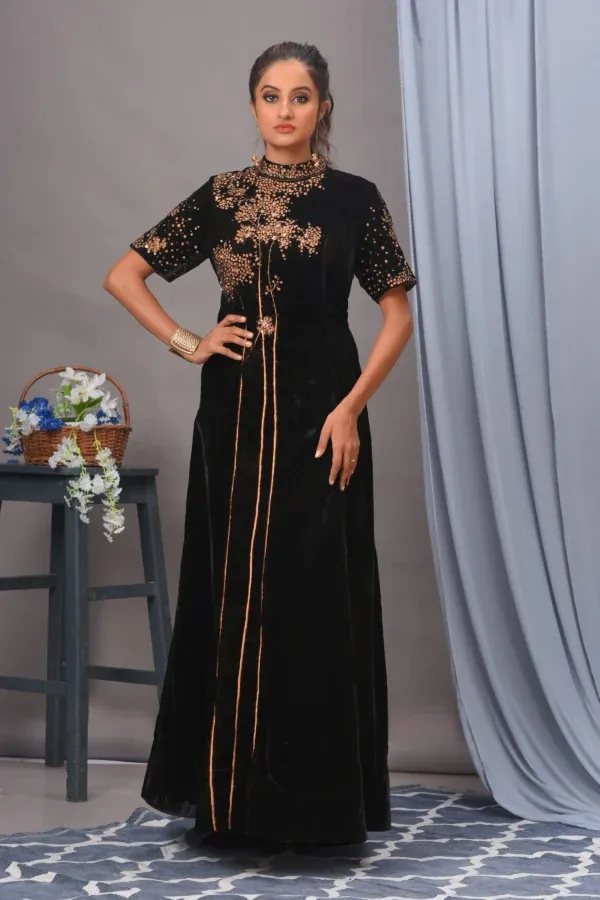 A luxurious black velvet gown by Vivek Kumar from Golden Muslin, featuring a mandarin collar and intricate floral cutdana and sequins work.