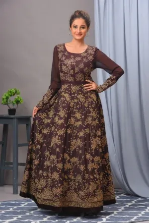 A coffee-colored Matka silk gown by Vivek Kumar from Golden Muslin, featuring intricate antique gold embroidery and a contemporary silhouette.