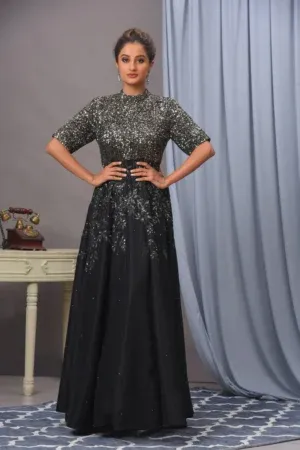 A handcrafted black crepe gown from Golden Muslin By Vivek Kumar featuring intricate embroidery and shimmering sequins for a flattering silhouette.