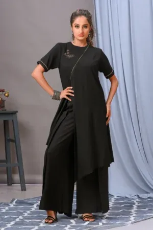 A black cotton rayon front-open asymmetric tunic from Golden Muslin By Vivek Kumar, featuring minimal hand embellishments and paired with chic black pants.