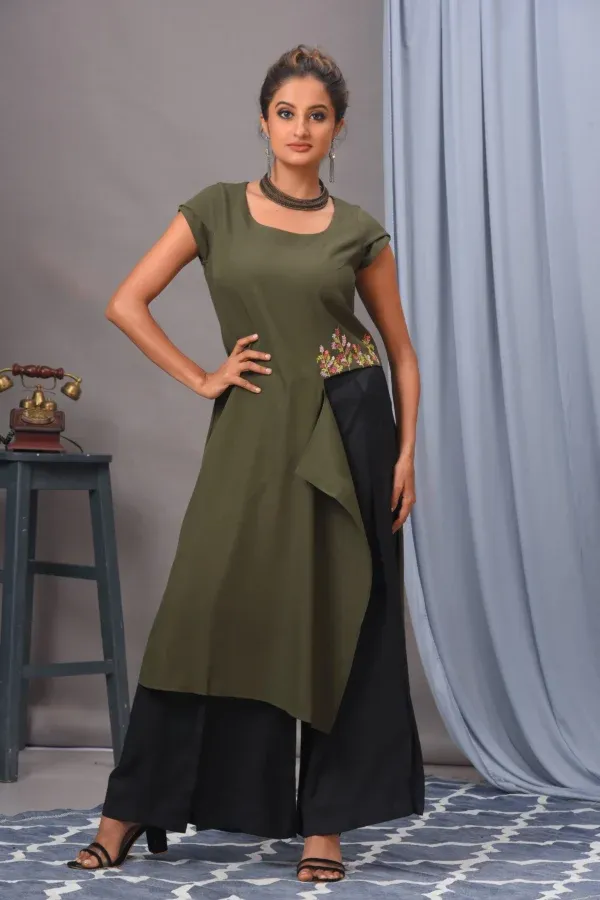 Olive green moss crepe tunic with waist thread work by Vivek Kumar from Golden Muslin with black pants.