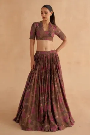 “Golden Muslin walnut brown Moonga silk lehenga set with stylized V-neck printed blouse and fagoting-stitched panels.”