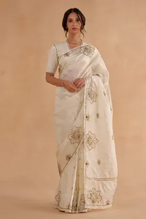 “Golden Muslin vintage ivory Paper Tussar silk saree with gold Zardozi chintz-inspired embroidery and matching blouse with subtle sleeve and neckline detailing.”