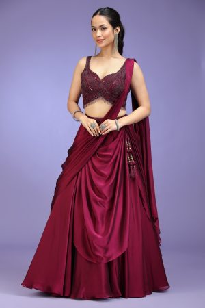 Golden Muslin burgundy poly silk pre-draped embroidered lehenga set with sleeveless embroidered blouse and attached pre-draped dupatta