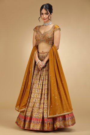 Golden Muslin mustard silk embroidered lehenga set with cap-sleeved embroidered blouse