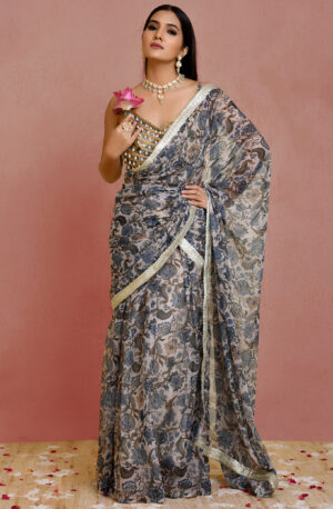 Beige and blue floral print pre-draped georgette saree with lace detailing and pearl-embellished blouse from Golden Muslin by Priyanka Rathore.