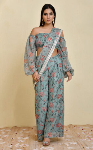 Blue pre-draped floral printed georgette pant saree with lace border detailing and smocked blouse with balloon sleeves in Golden Muslin by Priyanka Rathore