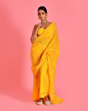 Yellow fusion saree with palazzo pants in Golden Muslin by Priyanka Rathore with attached pallu and pearl embellishments