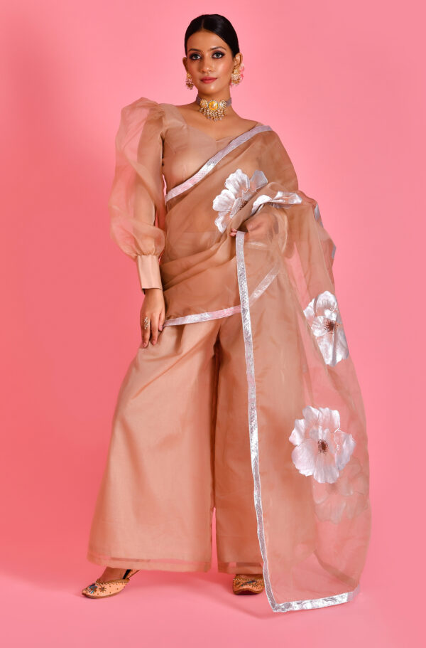 Beige pre-draped saree with palazzo pants, attached pallu, hand-painted detailing and blouse from Golden Muslin by Priyanka Rathore