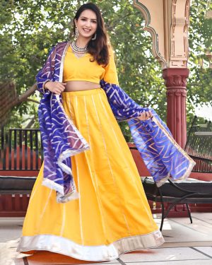 Yellow cotton silk lehenga with zari lappa borders and blue zari-woven organza dupatta from Golden Muslin by Priyanka Rathore.