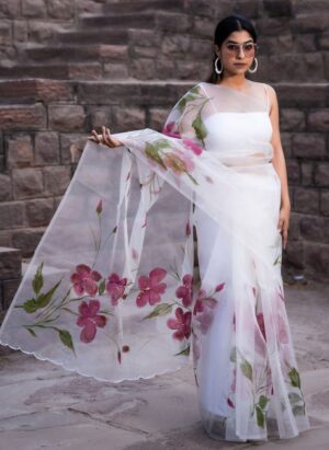 Snow white pure organza saree with hand-painted floral creepers from Golden Muslin by Priyanka Rathore