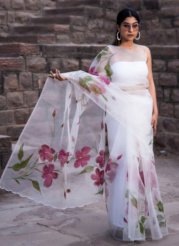 Snow white pure organza saree with hand-painted floral creepers from Golden Muslin by Priyanka Rathore