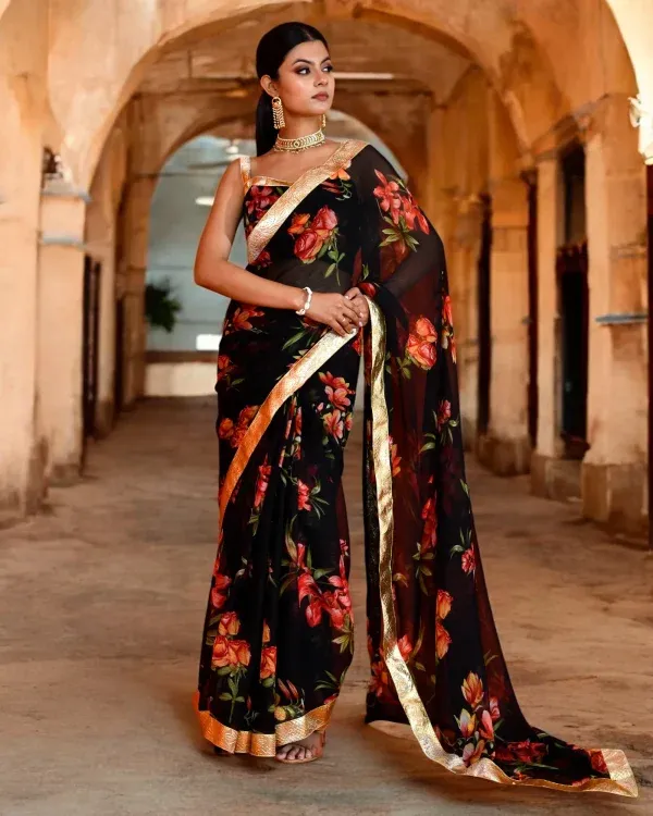 An elegant black chiffon saree featuring refined floral prints and a graceful drape from Golden Muslin by Priyanka Rathore, perfect for evening festive wear.