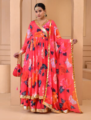 Coral georgette floral print sharara set with flared angrakha-style kurta featuring gota detailing, matching sharara, coordinated dupatta, and complementary potli in Golden Muslin by Priyanka Rathore