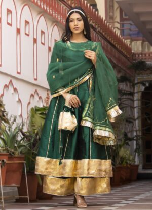 Green taffeta silk sharara set with long kurta featuring gota detailing and three-quarter sleeves, matching sharara with gota border, green organza dupatta with aari embroidery and gota accents, and coordinating potli in Golden Muslin by Priyanka Rathore