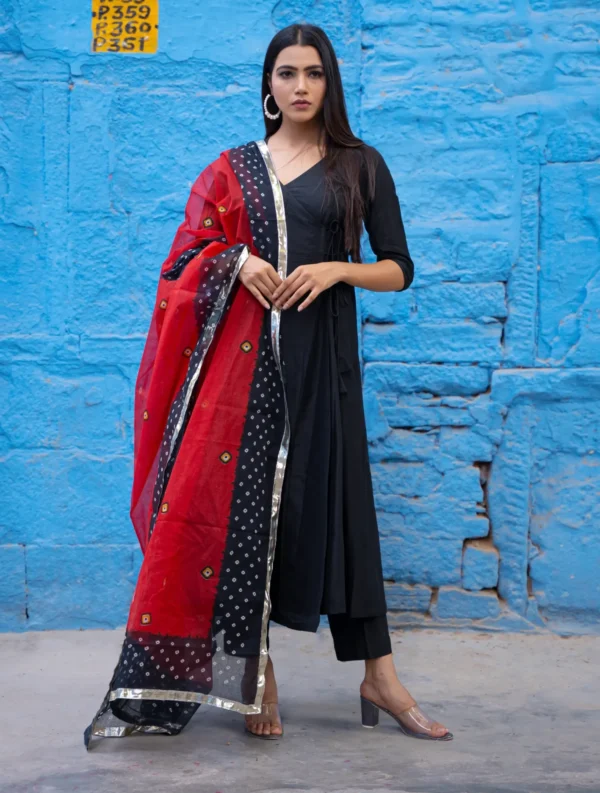Black Angrakha suit set with wrap-style kurta and straight-fit pants, offering timeless elegance, effortless comfort, and refined festive appeal, Golden Muslin by Priyanka Rathore.