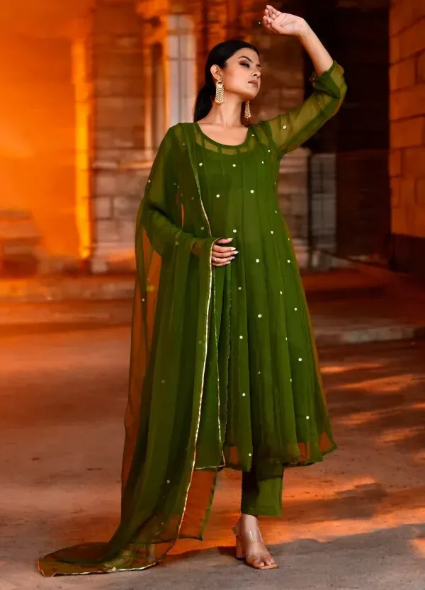 An elegant olive green georgette Anarkali featuring intricate aari embroidery and a fluid silhouette from Golden Muslin by Priyanka Rathore, perfect for festive celebrations.