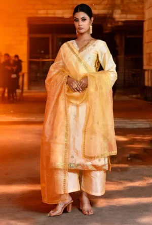 Golden Muslin by Priyanka Rathore light pastel yellow raw silk suit set featuring delicate gota patti work, crafted for timeless festive elegance and refined traditional sophistication.