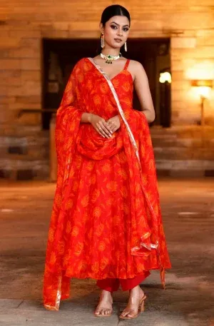 Vibrant red floral printed chiffon Anarkali suit set featuring a flowing silhouette from Golden Muslin by Priyanka Rathore for festive wear.