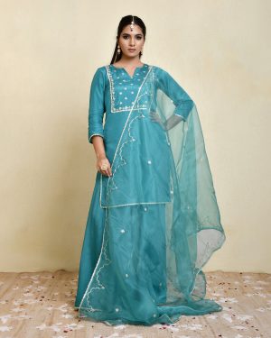 Teal Uppada silk sharara set with aari embroidered kurta, lace borders, three-quarter sleeves, matching sharara and embroidered dupatta in Golden Muslin by Priyanka Rathore