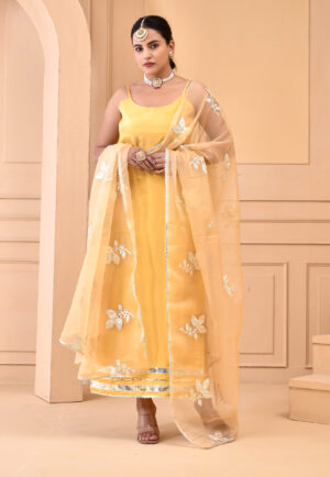 Yellow Uppada silk straight kurta set with scoop neckline, noodle straps, gota lace detailing and embroidered organza dupatta in Golden Muslin by Priyanka Rathore
