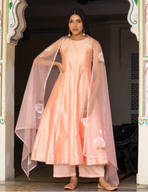 Peach taffeta silk long-length kali-pattern anarkali with palazzo and hand-painted organza dupatta from Golden Muslin by Priyanka Rathore.