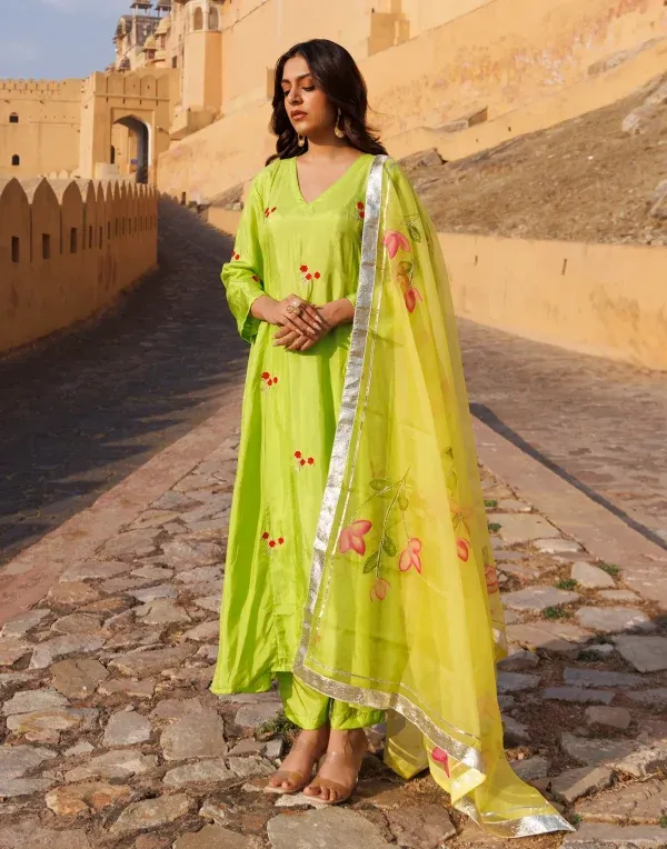 Green Uppada silk kurta set with aari embroidered floral motifs and fluid drape from Golden Muslin by Priyanka Rathore